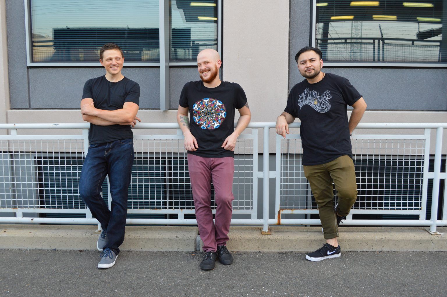 A Shrewdness of Apes band members posing together along a sidewalk.