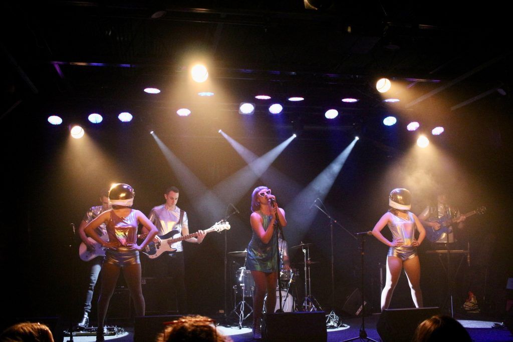 Shelley Star and the Galaxy performing on stage in space themed outfits.